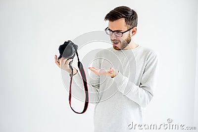 Puzzled photographer with camera Stock Photo