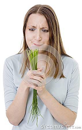 Puzzled woman with bunch of grass Stock Photo