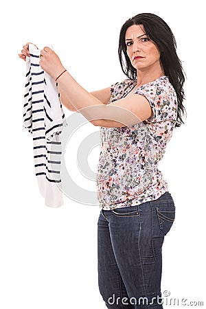 Puzzled woman holding new shirt Stock Photo