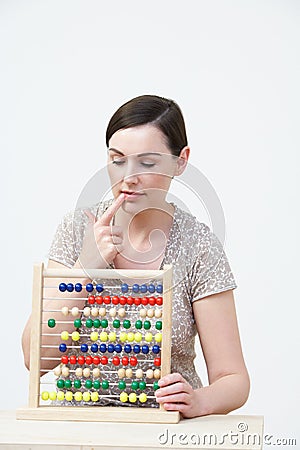 Puzzled Woman Using Abacus Stock Photo