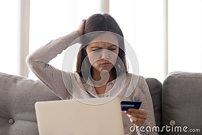 Puzzled young woman forgot credit card password, finance problem Stock Photo