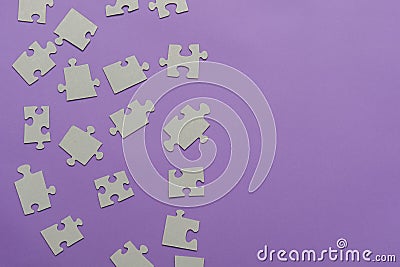 Puzzles on a purple background as a symbol of autism. Conceptual vision of the problem of autistic children Stock Photo