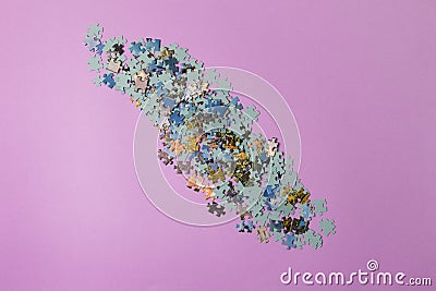 Puzzles on purple colored paper background, Top view. Close-up Stock Photo