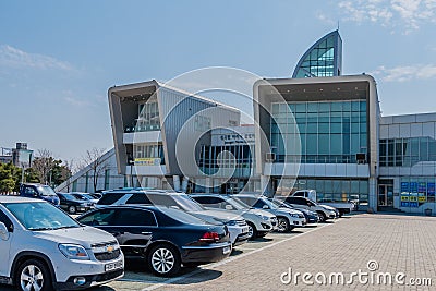 Rows of cars parked in front of Jeongok Marina Clubhouse on sunny morning Editorial Stock Photo