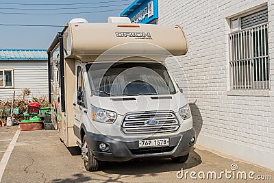 Ford camper van parked behind Korean fishing supply store Editorial Stock Photo