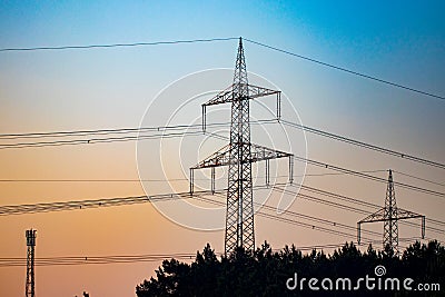 Pylon and transmission power line in sunset Stock Photo