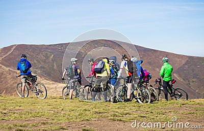 Pylypets, Ukraine - 15 September, 2019: Group of tourists friends ride bicycles along the top of mountains Editorial Stock Photo