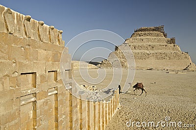 Pyramid of Djoser and Temple Wall with Cobras in Saqqara Stock Photo