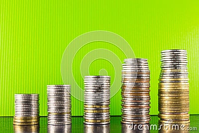 Pyramid gold and silver coins on a green background dark desktop Stock Photo