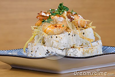 Pyramid of maki roll with fried shrimps, tempura vegetables, sesame and rocket decoration Stock Photo