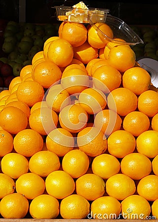 Pyramid of oranges in store front display Stock Photo