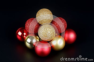 Pyramid from a red and gold shiny and matte christmas balls close up view Stock Photo