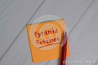 Pyramid Schemes write on sticky notes isolated on office desk Stock Photo