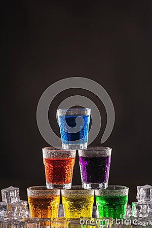 Pyramid of shots with colorful alcohol on ice Stock Photo