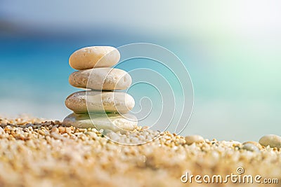 Pyramid Stones Balance at sea background with sunlight Stock Photo