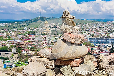 Pyramid of stones and panoramic view of Tbilisi city. Georgia Stock Photo