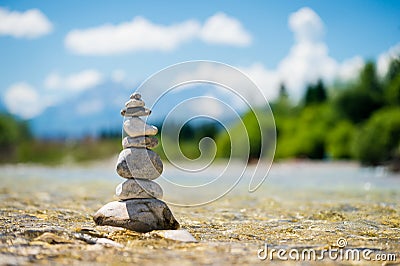 Pyramid of stones standing in the water Stock Photo