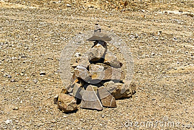 Pyramid of stones on stony terrain Stock Photo