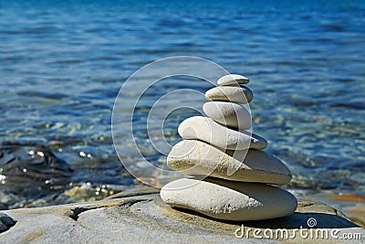 Pyramid of stones zen balance in sea shore Stock Photo