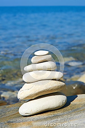 Pyramid of stones zen balance in sea shore Stock Photo