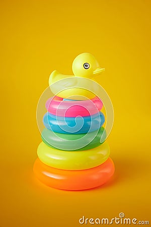 Pyramid toy. Circle Plastic Colorful. The newborn children bathing fun moments get baby and mother. Toys for Children on yellow ba Stock Photo