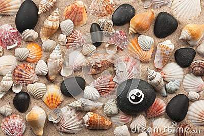 Pyramid yinyang stands on seashells and stones Stock Photo