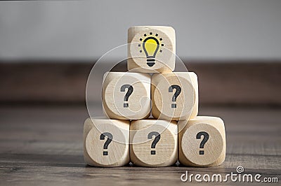 Pyramide made of cube and dice with question tags and light bulb - metaphor for problem and solution Stock Photo