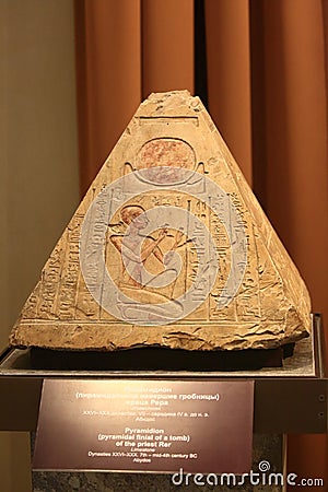 Pyramidion, the top of the funerary pyramid with the image of the sun, a male figure and hieroglyphs. Ancient Egypt Editorial Stock Photo
