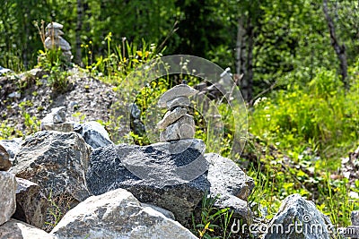 Pyramids of stones in Karelia. Pyramids of stones on a background of green forest Stock Photo