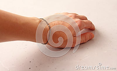 Pyrite bracelet. Bracelet made of stones on hand from natural stone Pyrite. Bracelet made of natural stones. Handmade jewelry. Stock Photo