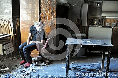 Pyromaniac man in a room with burnt objects, madness concept Stock Photo