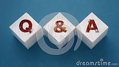 Q and A on wooden blocks Close-up Shot . Question and answers support center business concept Stock Photo