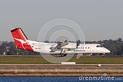 QantasLink Qantas deHavilland DHC-8 Dash 8 twin engined regional airliner aircraft departing Sydney Airport. Editorial Stock Photo