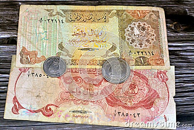 Qatari Money, money background of old coins and banknotes of riyals of different eras, old vintage retro Qatar money coin and Stock Photo