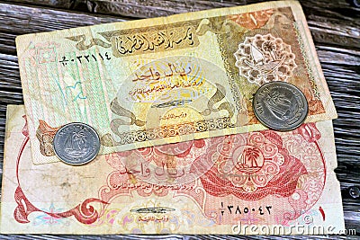 Qatari Money, money background of old coins and banknotes of riyals of different eras, old vintage retro Qatar money coin and Stock Photo