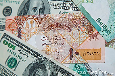 Qatari riyals and American dollars, Stock Photo