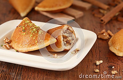 Qatayef Ramadan Traditional Sweets walnut jwz on wood background Stock Photo