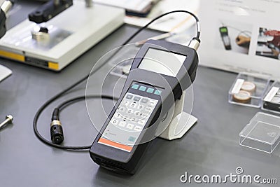 QC operator calibrate thickness testing machine before inspection painting quality and coating quality Stock Photo