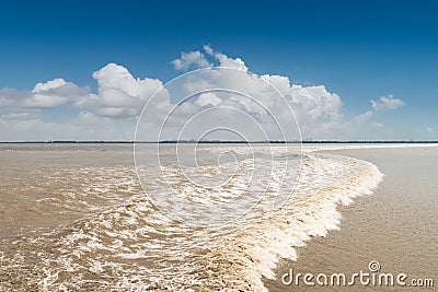 Qiantang river tide against a blue sky Stock Photo