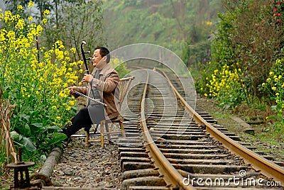 Qianwei China-A man playing the chinese fiddle Editorial Stock Photo