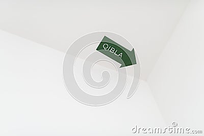 A Qibla arrow sign for a Muslim prayer direction Stock Photo