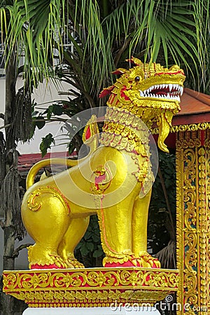 Qilin asian mythological guard goolden statue in Thailand wat Stock Photo