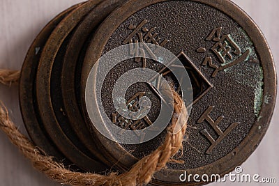 Qing dinasty coins through a string macro shot Stock Photo