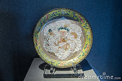 The Qing Emperor Qianlong 1735 antique, enamelled copper Yellow Peony brocade Medallion wrapped cloud dragon disc. Editorial Stock Photo