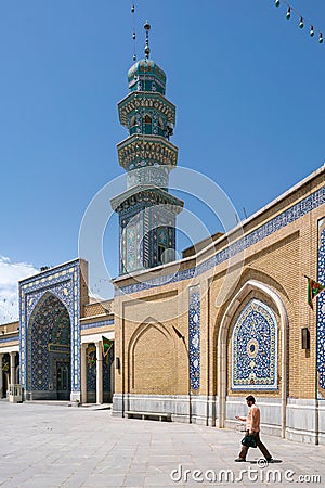 Qom, Iran - 04.20.2019: Believers walking under minarets in the courtyard of Fatima Masumeh Shrine. Hazrat Masumeh Holly Shrine Editorial Stock Photo