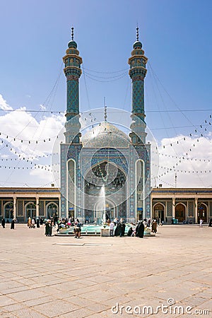 Qom, Iran - 04.20.2019: Believers walking under minarets in the courtyard of Fatima Masumeh Shrine. Hazrat Masumeh Holly Shrine Editorial Stock Photo