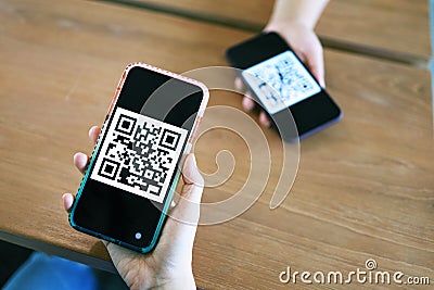 Qr code payment. Woman scanning QR code online shopping cashless technology concept Stock Photo