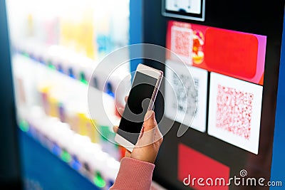 Qr code payment, online shopping, cashless technology concept. women hand hold the smartphone for payment at vendor machine Stock Photo