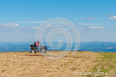 Quad biking in the mountains. Equipped ATV driver Editorial Stock Photo