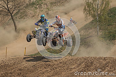 Quad race - duel between two riders in a jump Editorial Stock Photo